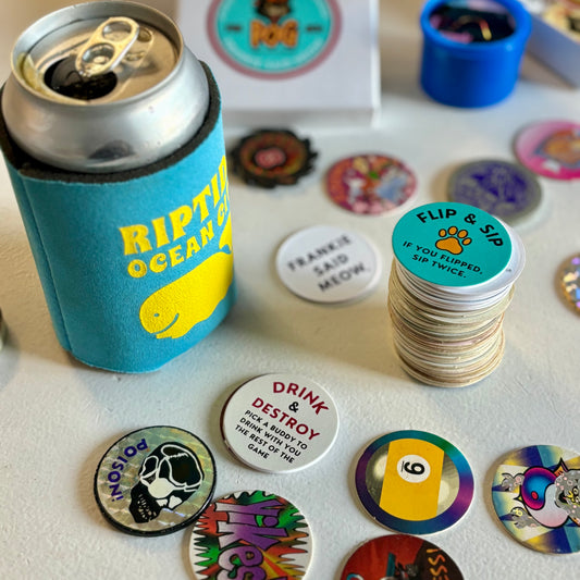 Frankie Said Meow Milk Caps and Vintage 90's pog stacks and boxes next to a beer