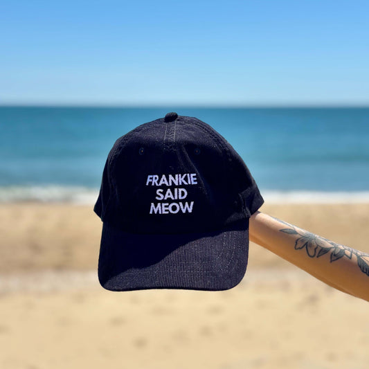 Corduroy trucker hat with Frankie Said Meow embroidered logo on beach in Ocean City, Maryland