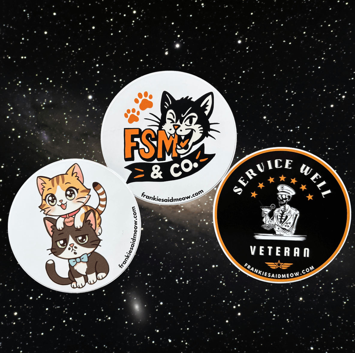A photo of three glossy 3-inch round stickers from Frankie Said Meow. The set includes a chibi-style sticker of orange tabby Frankie sitting on tuxedo cat Coqui, a sticker of Coqui biting the FSM & Co. logo, and a vintage-inspired “Service Well Veteran” sticker with a skeleton bartender in uniform. All three are shown against a starry galaxy background.