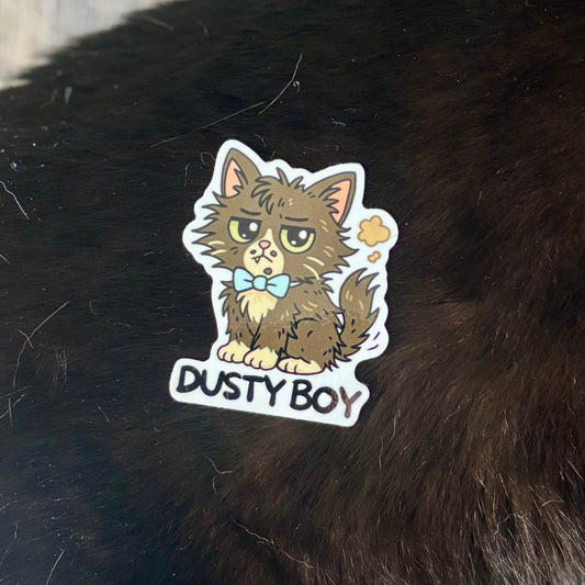 Sticker of a cat named 'Dusty Boy' on a dark surface