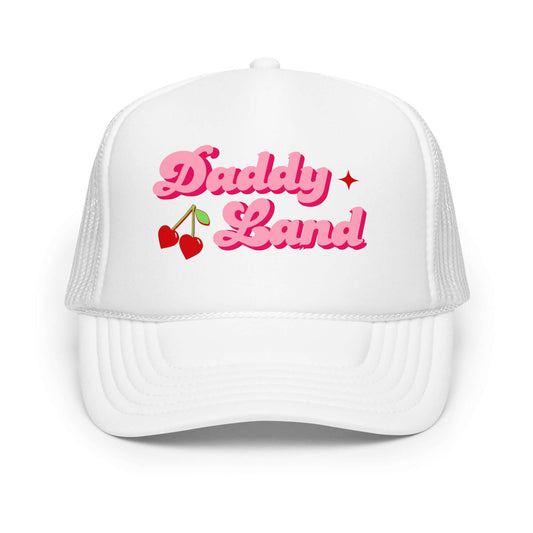 White foam trucker hat with bold pink retro text reading “Daddy Land” with cherries graphic.