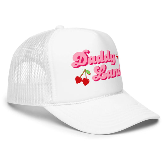 White foam trucker hat with bold pink retro text reading “Daddy Land” with cherries graphic.
