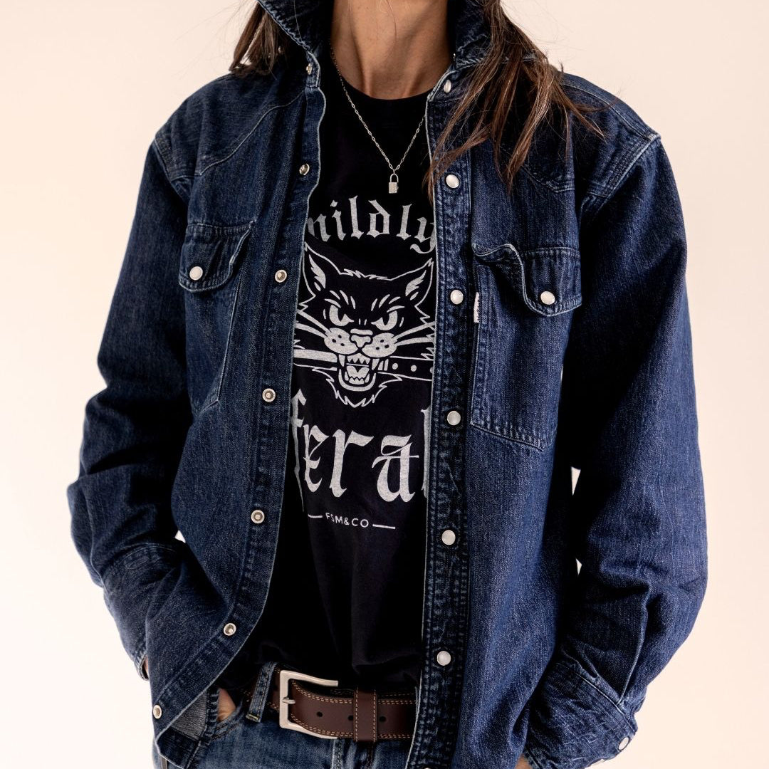 Person wearing a black t-shirt with 'mildly feral' screen print design by Frankie Said Meow and Cracked ego. 