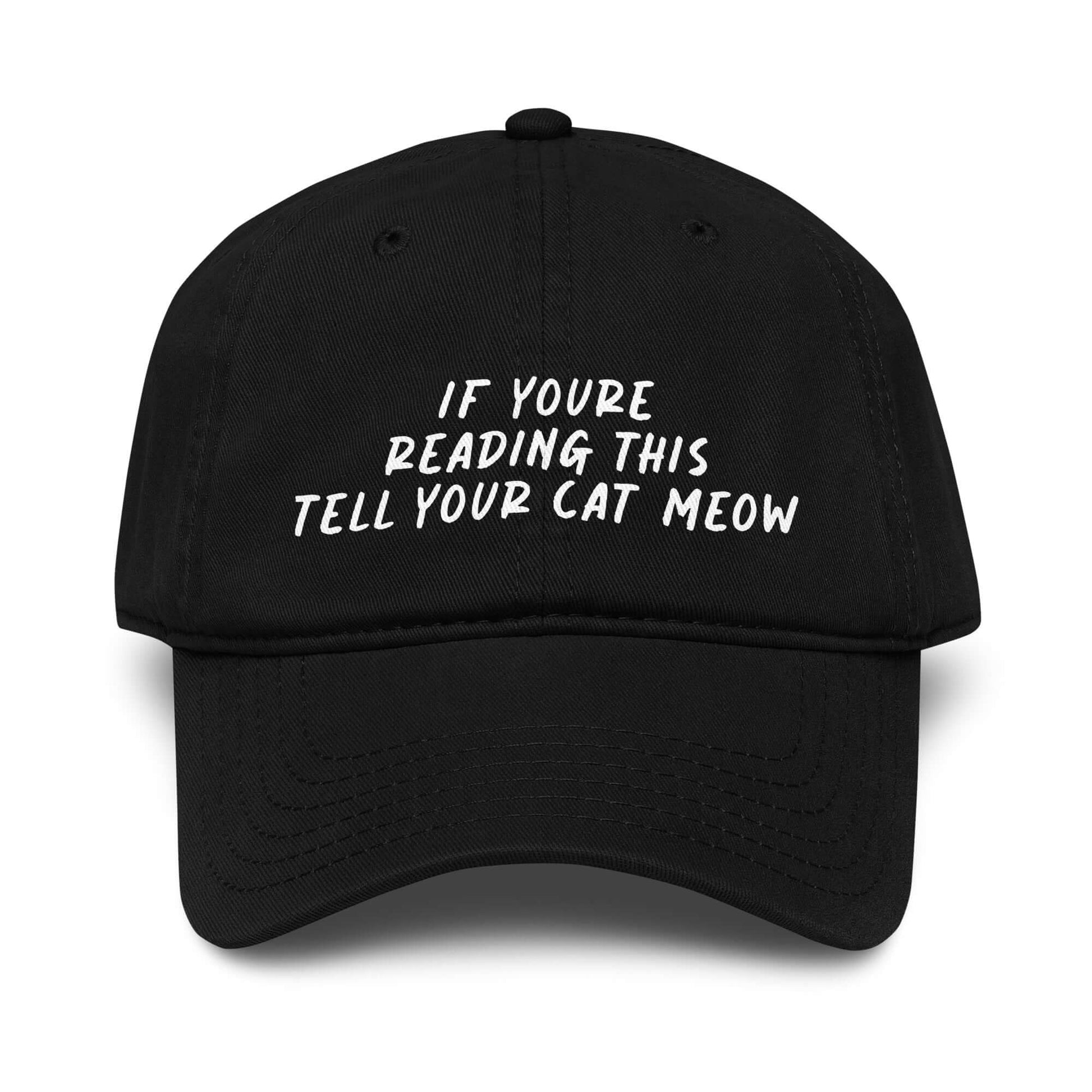 Black washed low-profile baseball cap with white embroidered text reading “if you’re reading this tell your cat meow.