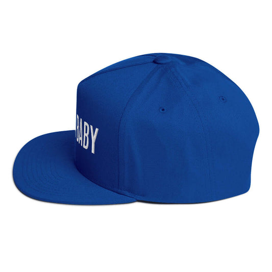 Royal blue flat bill snapback hat with white "JUST A BABY" embroidery and green undervisor.