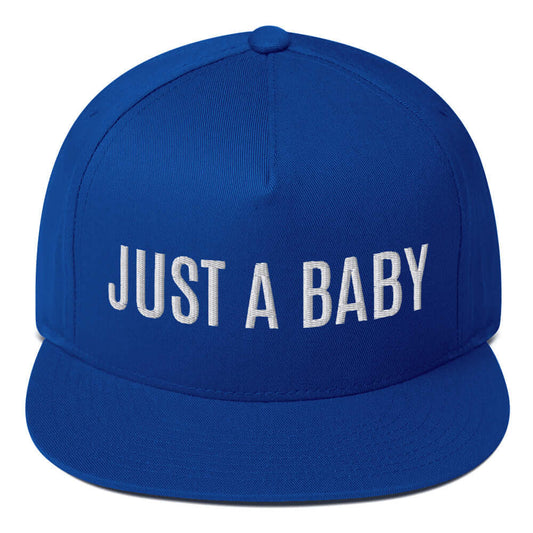 Royal blue flat bill snapback hat with white "JUST A BABY" embroidery and green undervisor.